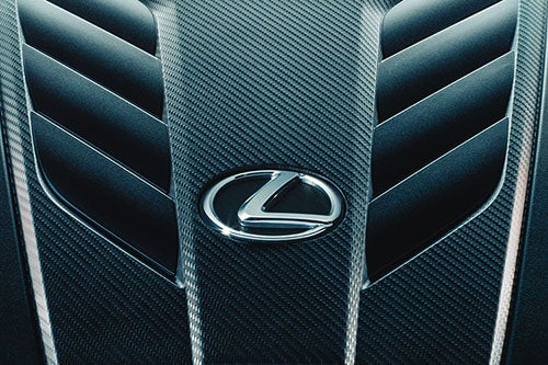 Close-up of an engine featuring the Lexus emblem.